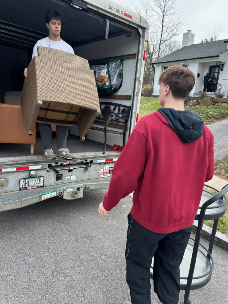 Workers moving furniture out of a truck